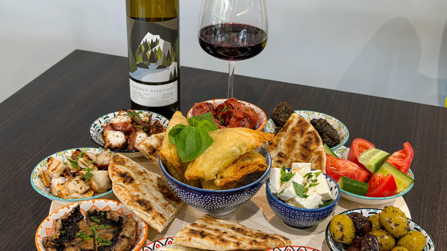 Sharing meze board with dips, pita and wine