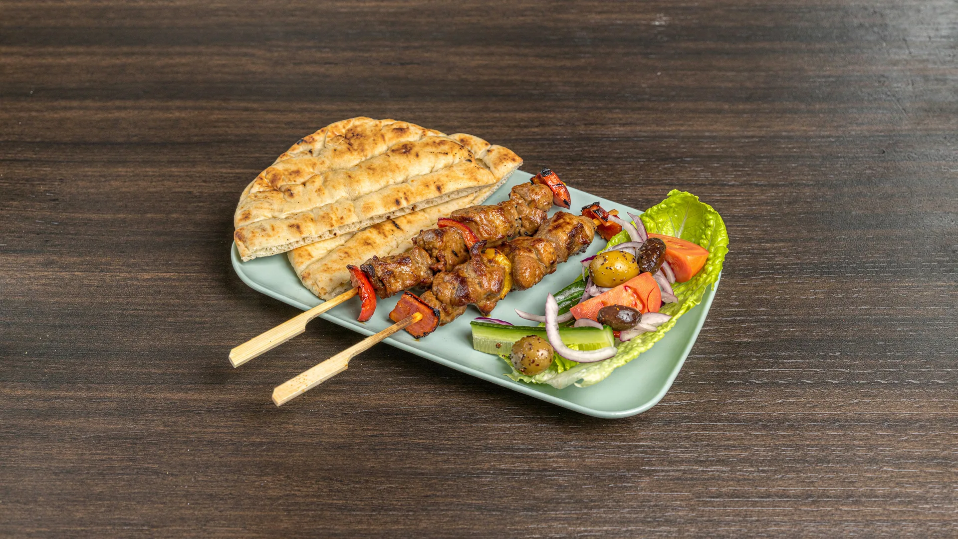 Souvlaki skewers with pita and salad
