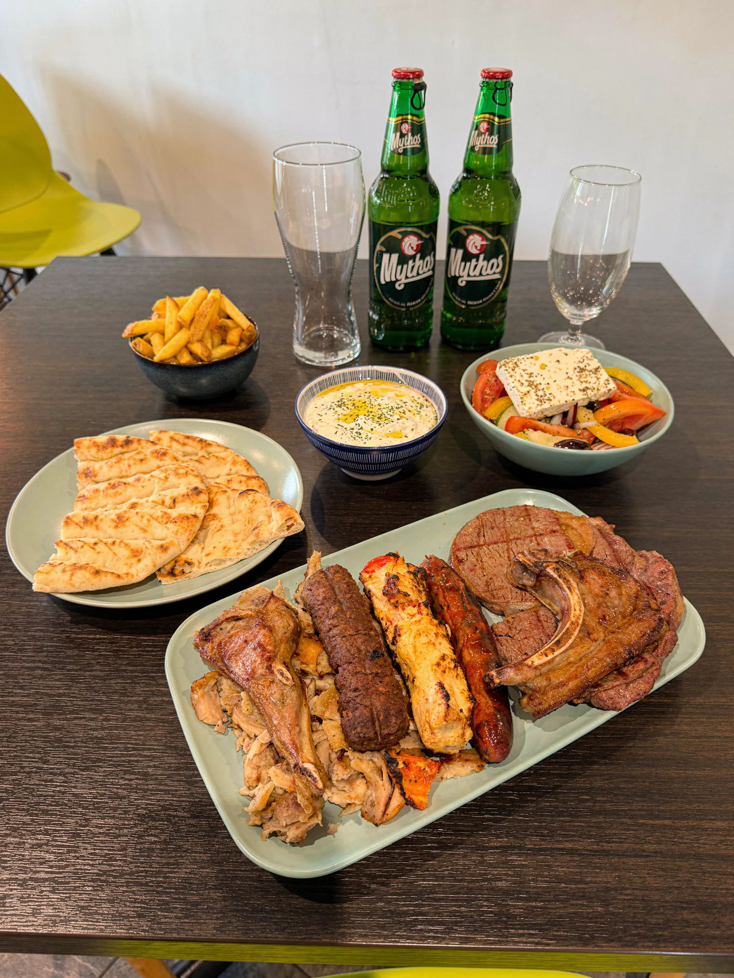 Mixed grill with pita, fries, tzatziki and Greek salad