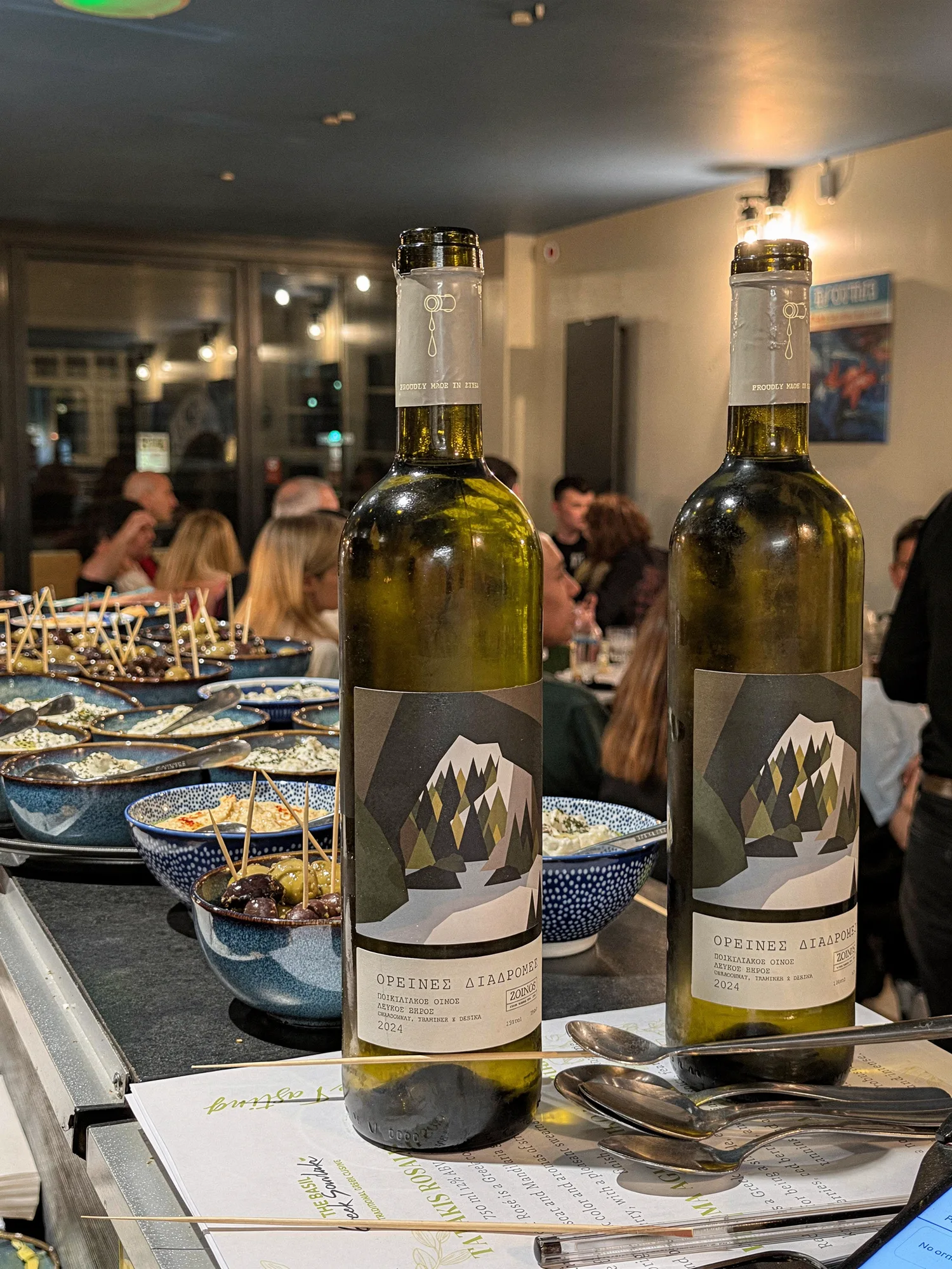 Oreines Diadromes white wine bottles at a tasting on the table